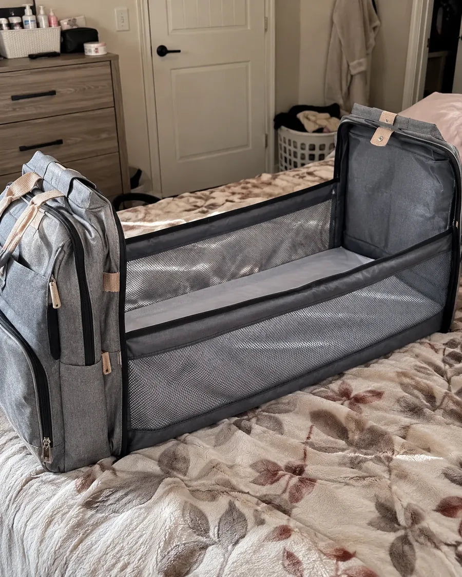 Buyer's photo: the backpack's fold-out changing station opened on a bed